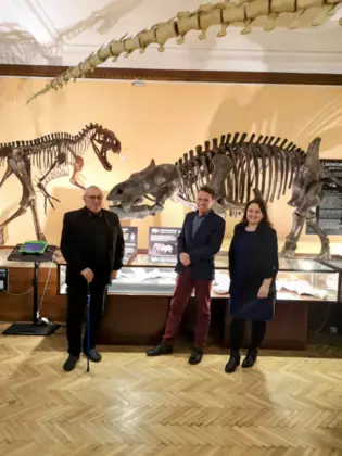 Zdjęcie wystawy w Muzeum Ewolucji. W tle stoją modele szkieletów lisowicji i smoka. Z przodu stoi od lewej: Marek Błyszcz, Tomasz Sulej i Anna Majowska.